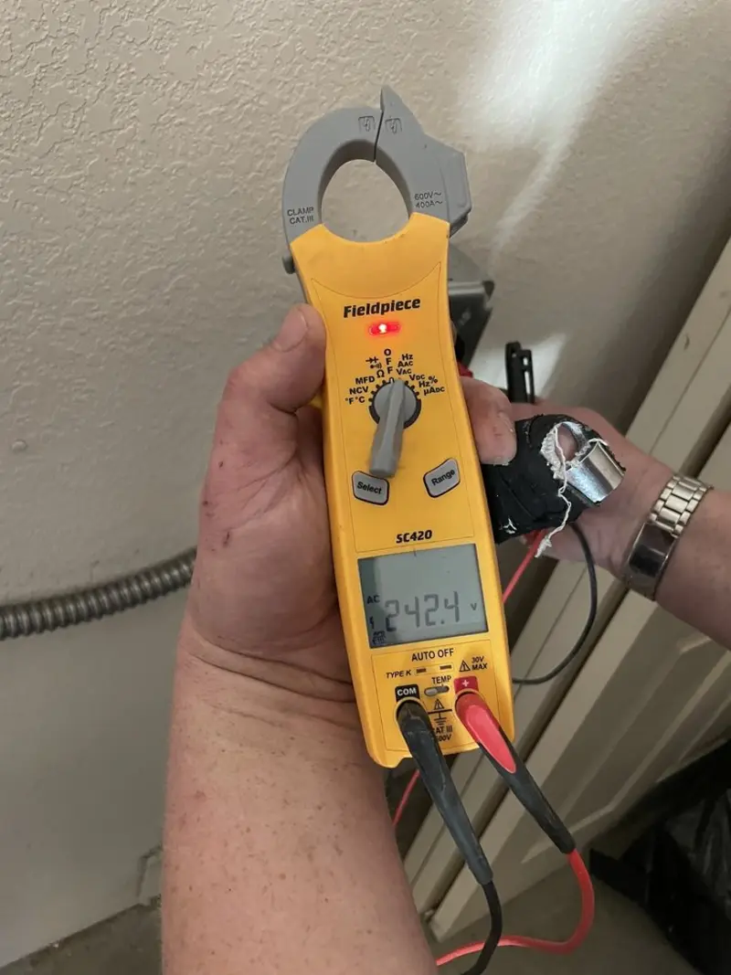 Voltage testing with clamp meter during Recessed Lighting Installation in Crandall